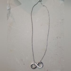 Silver and cubic zirconia eternity knot necklace.